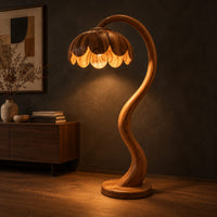 Floor lamp with an arching stem and a petal shaped shade, three-quarter view showing the grain