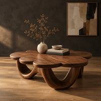 Flower shaped coffee table on a base of looping rounded arches in a dark studio against a charcoal plaster wall