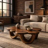 Flower shaped coffee table on a base of looping rounded arches in an industrial loft living room with exposed brick