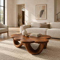 Flower shaped coffee table on a base of looping rounded arches in a bright open plan living room
