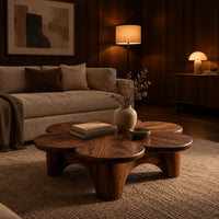 Petal shaped coffee table on thick round legs in an evening living room with walnut wall paneling