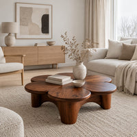 Petal shaped coffee table on thick round legs in a Scandinavian living room with white walls