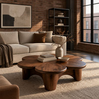 Petal shaped coffee table on thick round legs in an industrial loft living room with exposed brick