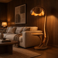 Wooden floor lamp with a flower shaped petal shade, arched stem and side tray in an evening living room with walnut wall paneling