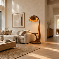 Wooden floor lamp with a flower shaped petal shade, arched stem and side tray in a bright open plan living room