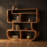 Bookshelf with stacked open cubbies and flowing sculpted sides in a dark studio against a charcoal plaster wall