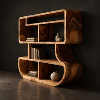 Bookshelf with stacked open cubbies and flowing sculpted sides, three-quarter view showing the grain