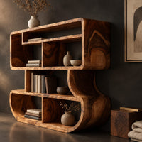 Corner detail of bookshelf with stacked open cubbies and flowing sculpted sides beside wood, brass and linen samples