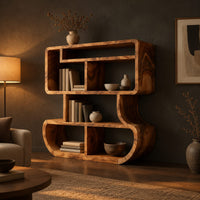 Bookshelf with stacked open cubbies and flowing sculpted sides in a dark living room at golden hour