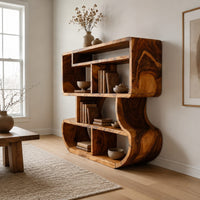 Bookshelf with stacked open cubbies and flowing sculpted sides in a Scandinavian living room with white walls