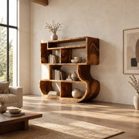 Bookshelf with stacked open cubbies and flowing sculpted sides in a bright open plan living room