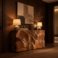 Console table cabinet with two doors carved in flowing wood grain relief in an evening entryway with walnut wall paneling
