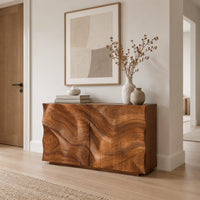 Console table cabinet with two doors carved in flowing wood grain relief in a Scandinavian entryway with white walls
