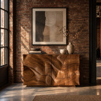 Console table cabinet with two doors carved in flowing wood grain relief in an industrial loft entryway with exposed brick