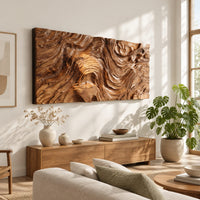 Wide wall art panel with deep carved wood grain ripples and a central whorl in a bright sunroom with green plants