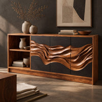 Corner detail of wood sideboard with charcoal panels, a flowing carved band and an open shelf bay beside wood, brass and linen samples