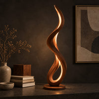 Corner detail of slim floor lamp shaped as one flowing ribbon with an open loop beside wood, brass and linen samples