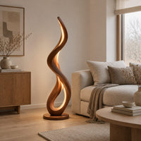 Slim floor lamp shaped as one flowing ribbon with an open loop in a Scandinavian living room with white walls