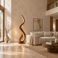 Slim floor lamp shaped as one flowing ribbon with an open loop in a bright open plan living room
