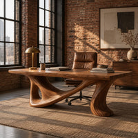 Smooth slab desk on a flowing sculpted base with an oval opening in an industrial loft home office with exposed brick