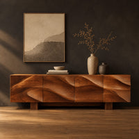 Sideboard with four flowing swirl carved panels on two block feet in a dark studio against a charcoal plaster wall