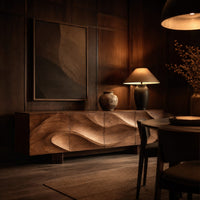 Sideboard with four flowing swirl carved panels on two block feet in an evening dining room with walnut wall paneling
