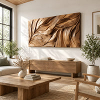 Wide wall art panel carved with flowing leaf vein ridges in a bright sunroom with green plants