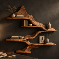 Corner detail of wavy wall shelves with staggered tiers joined by a flowing band beside wood, brass and linen samples