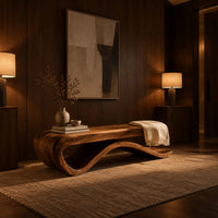 Long bench with a flat slab seat on a flowing wave base in an evening entryway with walnut wall paneling