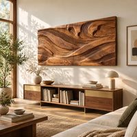 Wide carved wave relief wall panel made of two joined sections in a bright sunroom with green plants