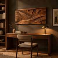 Wide carved wave relief wall panel made of two joined sections above a desk in a dark study corner