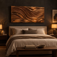 Wide wooden wall art panel with a flowing carved wave relief above a bed in a dusk lit bedroom