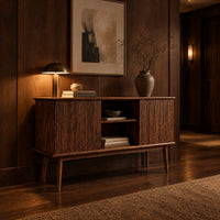 Console cabinet with fluted side doors, an open center shelf and tapered legs in an evening entryway with walnut wall paneling