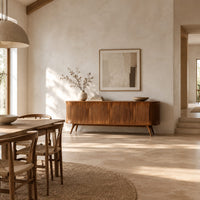Long sideboard with vertical fluted doors on slim tapered legs in a bright open plan dining room