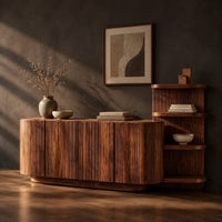 Long fluted sideboard with curved ends and an open shelf tower at one end, three-quarter view showing the grain