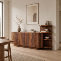 Long fluted sideboard with curved ends and an open shelf tower at one end in a Scandinavian dining room with white walls