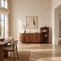 Long fluted sideboard with curved ends and an open shelf tower at one end in a bright open plan dining room