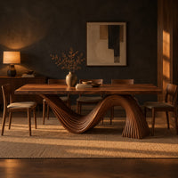 Dining table with a fluted wave shaped pedestal and rectangular top in a dark dining room at golden hour