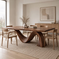 Dining table with a fluted wave shaped pedestal and rectangular top in a Scandinavian dining room with white walls