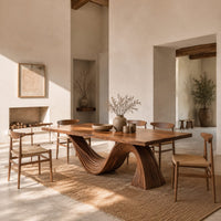 Dining table with a fluted wave shaped pedestal and rectangular top in a bright open plan dining room