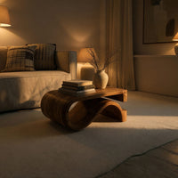 Folded S ribbon coffee table in an evening room lit by two lamps