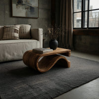 Folded S ribbon coffee table in a concrete and timber loft
