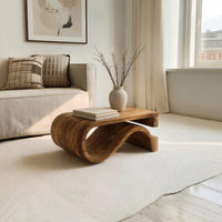 Folded S ribbon coffee table in an open plan space in daylight