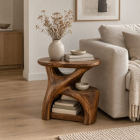 Forked branch side table with an oval top and open lower shelf in a Scandinavian living room with white walls