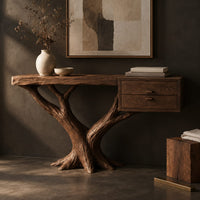 Corner detail of console table on a forked tree base with two drawers at one end beside wood, brass and linen samples