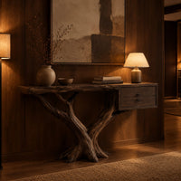 Console table on a forked tree base with two drawers at one end in an evening entryway with walnut wall paneling