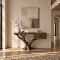 Console table on a forked tree base with two drawers at one end in a bright open plan entryway
