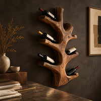 Corner detail of wine rack shaped like a branching tree trunk with forked arms for bottles beside wood, brass and linen samples
