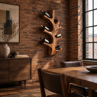 Wine rack shaped like a branching tree trunk with forked arms for bottles in an industrial loft dining room with exposed brick