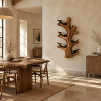 Wine rack shaped like a branching tree trunk with forked arms for bottles in a bright open plan dining room